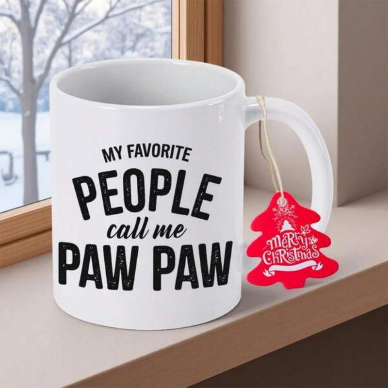 Tailorly White Ceramic 11 oz Mug - My Favorite People Call Me Paw Paw Festive Ceramic Surface Resting On Windowsill Near Snowy Window Mug