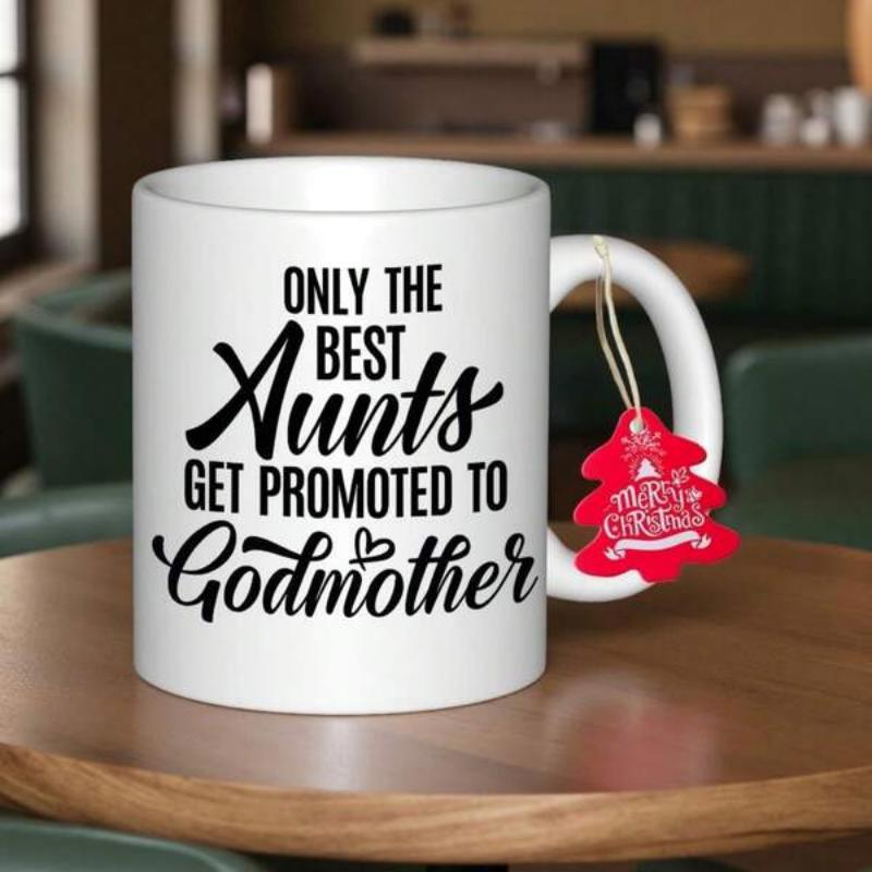 Tailorly White Ceramic 11 oz Mug - Only The Best Aunts Get Promoted To Godmother Elegant White Ceramic Coffee Cup On Polished Wooden Table Mug