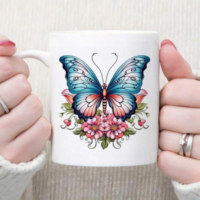 Tailorly White Ceramic 11 oz Mug - Intricate Blue Wings Resting Above Delicate Pink Blossoms And Green Foliage Butterfly