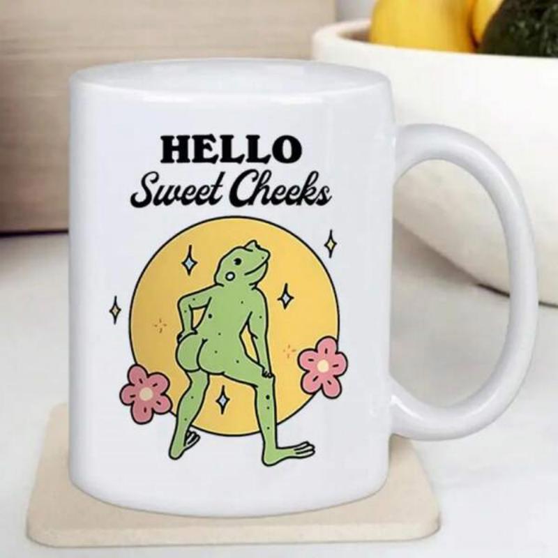 Tailorly White Ceramic 11 oz Mug - Hello Sweet Cheeks Whimsical Green Character Standing Before A Vibrant Yellow Circle Frog