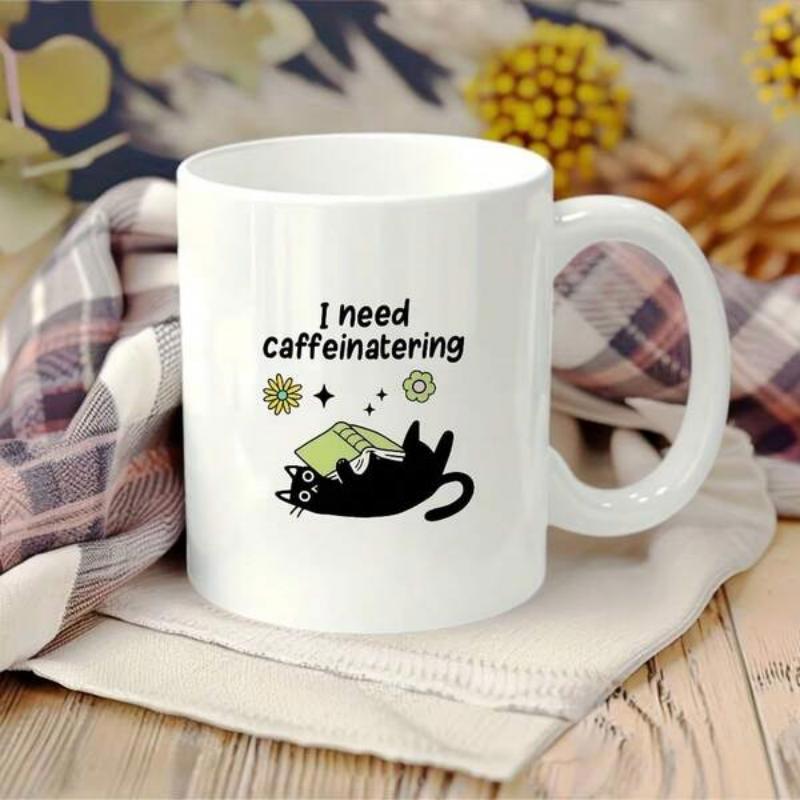 Tailorly White Ceramic 11 oz Mug - I Need Caffeinating Lazy Black Cat Holding Green Book Under Small Flowers And Twinkling Stars Cat