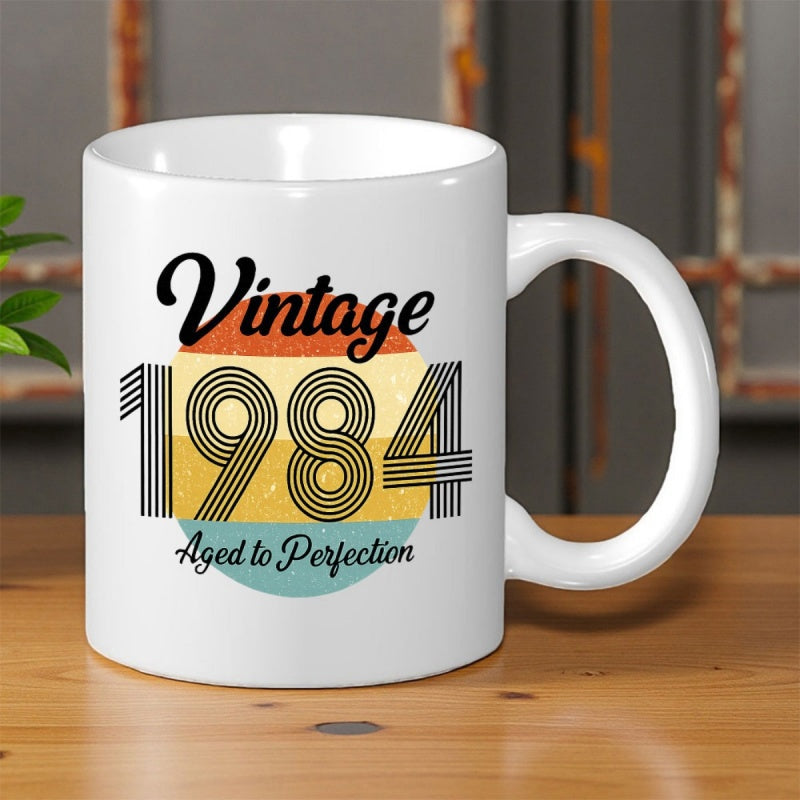 Tailorly White Ceramic 11 oz Mug - Vintage 1984 Aged To Perfection Retro Striped Circle Featuring Layered Warm Colors Under Weathered Texture Sun