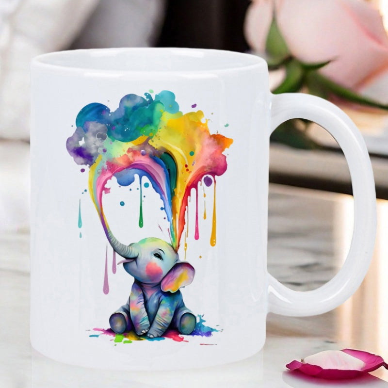 Tailorly White Ceramic 11 oz Mug - Vibrant Watercolor Splashes Forming Rainbow Clouds Above A Tiny Baby Sitting Elephant