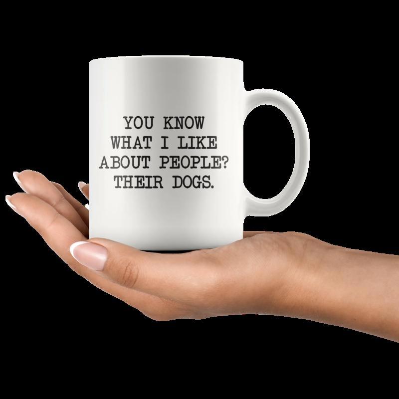 Tailorly White Ceramic 11 oz Mug - You Know What I Like About People Their Dogs Minimalist White Ceramic Held By Human Hand Over Dark Background Mug