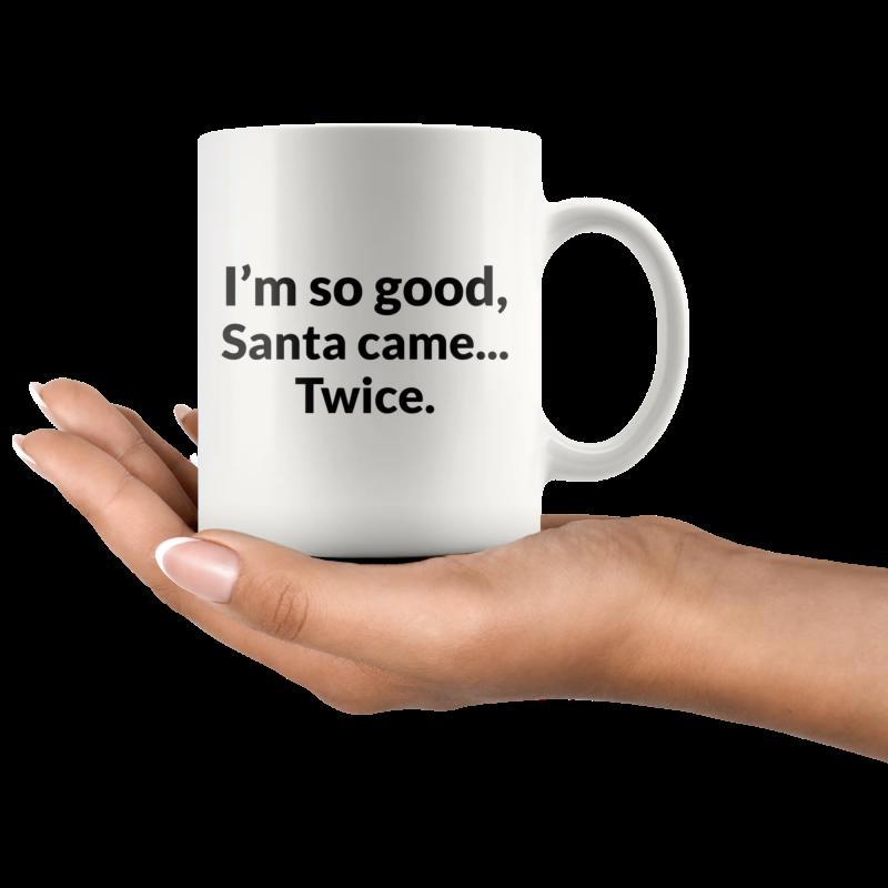 Tailorly White Ceramic 11 oz Mug - Im So Good Santa Came Twice Minimalist White Ceramic Cup Held By Human Hand Over Dark Background Mug