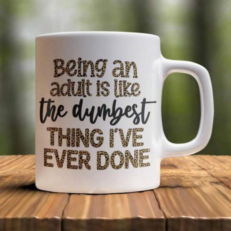 Tailorly White Ceramic 11 oz Mug - Being An Adult Is Like The Dumbest Thing I've Ever Done Simple White Ceramic Vessel Resting On A Rustic Wooden Surface Mug