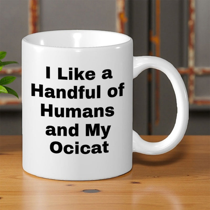 Tailorly White Ceramic 11 oz Mug - I Like A Handful Of Humans And My Ocicat Minimalist White Ceramic Vessel Featuring Bold Black Typography Text On Surface Mug