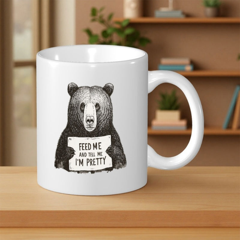 Tailorly White Ceramic 11 oz Mug - Feed Me And Tell Me I'm Pretty Black And White Hand Drawn Style Illustration Holding A Small Sign Bear