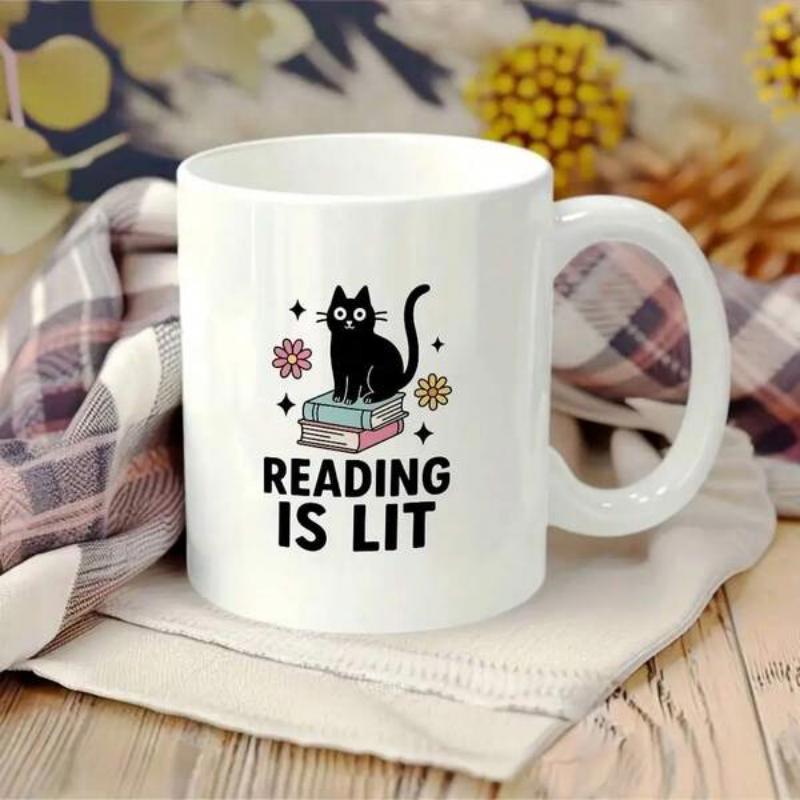 Tailorly White Ceramic 11 oz Mug - Reading Is Lit Stylized Black Cat Perched Upon Stacked Books Amidst Little Flowers Cat