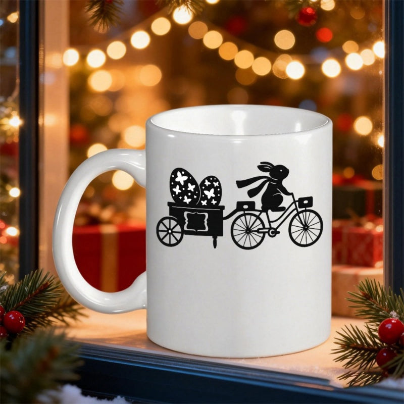 Tailorly White Ceramic 11 oz Mug - Whimsical Black Silhouette Riding A Bicycle Carrying Patterned Easter Eggs Rabbit