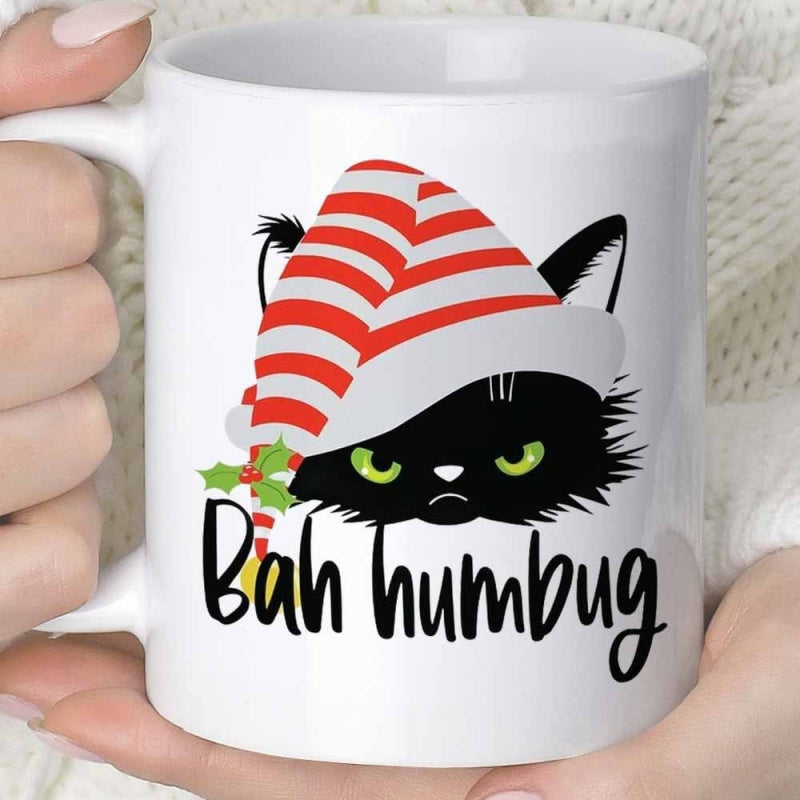 Tailorly White Ceramic 11 oz Mug - Bah Humbug Grumpy Black Feline Wearing Striped Santa Hat With Green Holly Leaves Cat