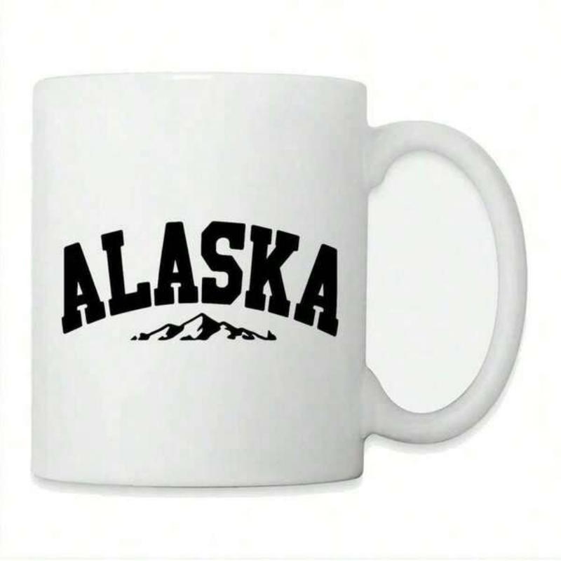 Tailorly White Ceramic 11 oz Mug - Alaska Arched Black Bold Lettering Resting Above A Sharp Silhouette Jagged Mountain