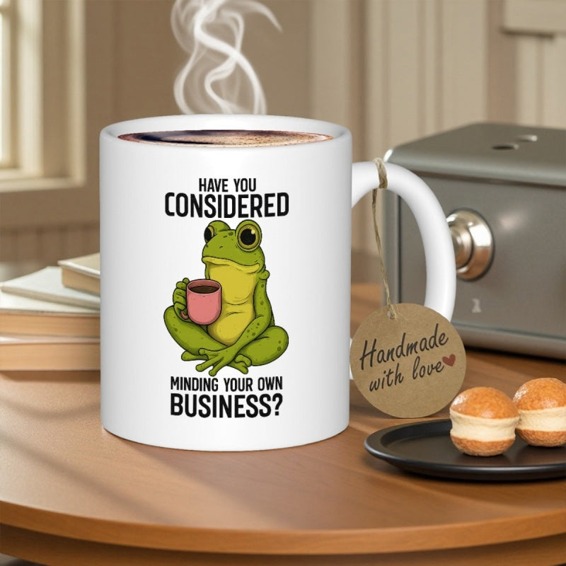 Tailorly White Ceramic 11 oz Mug - Have You Considered Minding Your Own Business Green Cartoon Character Sitting Cross Legged Holding Small Pink Coffee Mug Frog