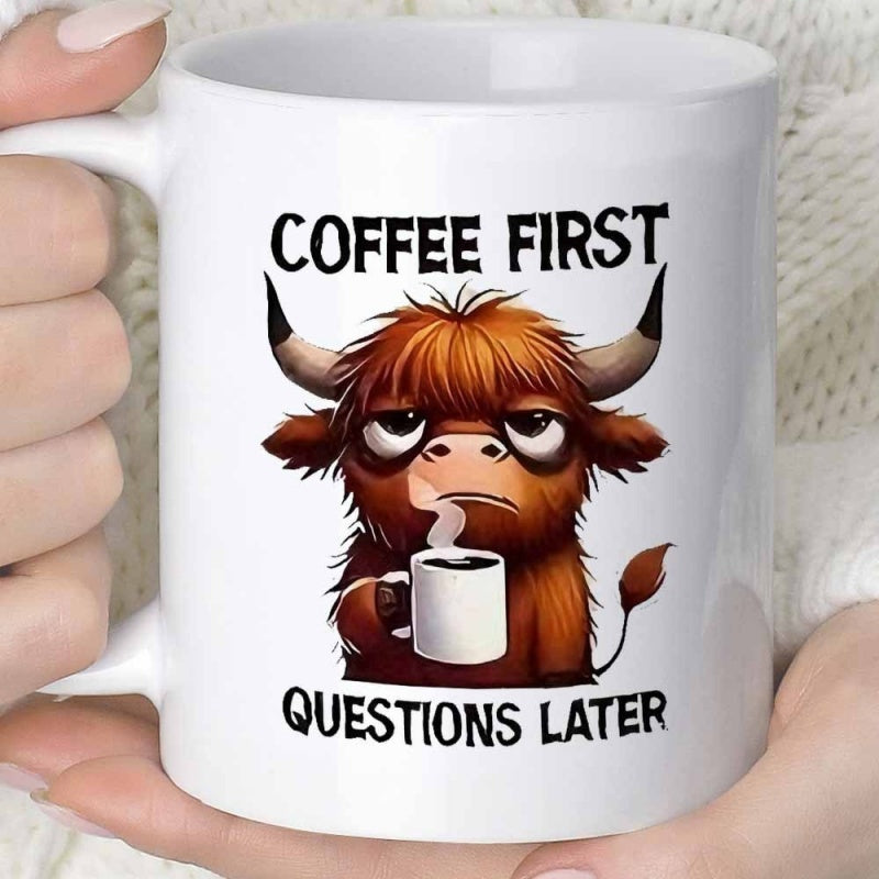 Tailorly White Ceramic 11 oz Mug - Coffee First Questions Later Shaggy Brown Highland Cow Holding Steaming Coffee Cup With Grumpy Expression Cow