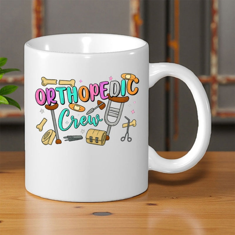 Tailorly White Ceramic 11 oz Mug - Orthopedic Crew Colorful Bubble Letters Surrounded By Medical Crutches Bandages And Bones Design