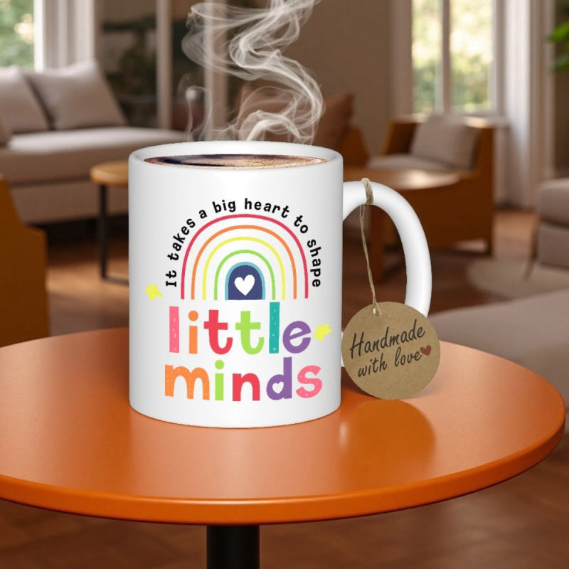 Tailorly White Ceramic 11 oz Mug - It Takes A Big Heart To Shape Little Minds Vibrant Multi Colored Arches Featuring A Heart Centered Under Text Rainbow