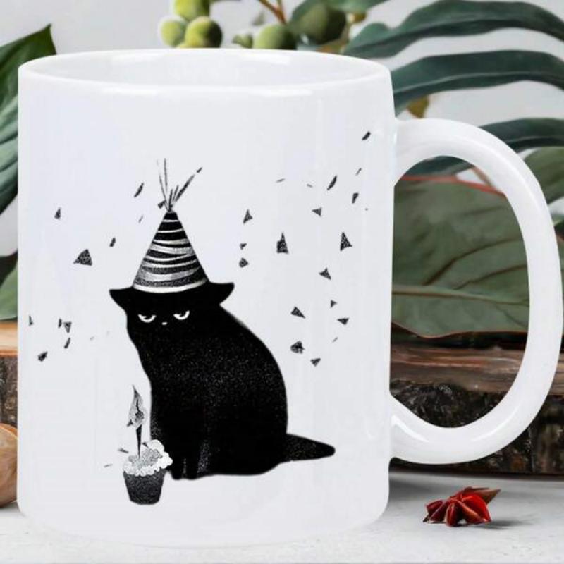 Tailorly White Ceramic 11 oz Mug - Minimalist Black Feline Wearing Striped Party Hat Beside Small Cupcake Cat