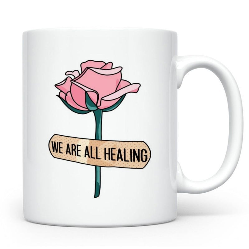 Tailorly White Ceramic 11 oz Mug - We Are All Healing Delicate Pink Rose Wrapped With Tan Adhesive Bandage On White Surface Rose