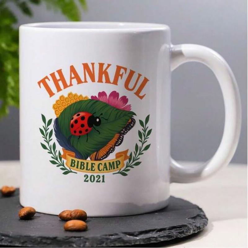 Tailorly White Ceramic 11 oz Mug - Thankful Bible Camp Resting On A Green Leaf Among Blooming Flowers And Laurel Wreath Ladybug