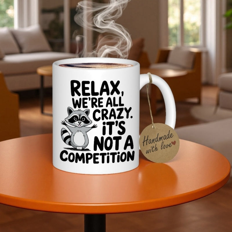 Tailorly White Ceramic 11 oz Mug - Relax We're All Crazy It's Not A Competition Playful Cartoon Raccoon With Arms Spread Wide Standing On White Surface Raccoon