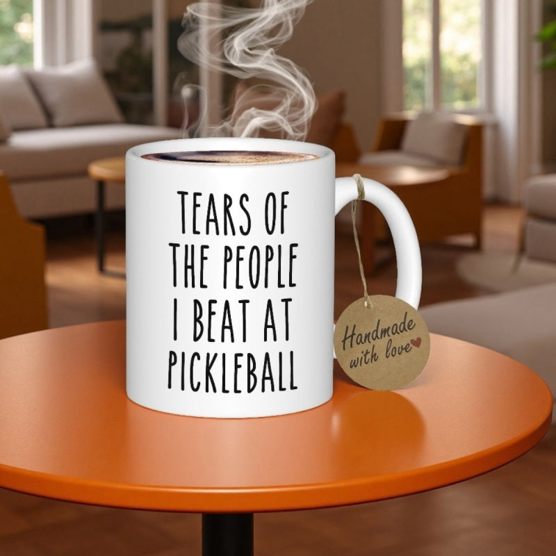 Tailorly White Ceramic 11 oz Mug - Tears Of The People I Beat At Pickleball Clean White Ceramic Vessel Resting Upon A Polished Orange Surface Mug