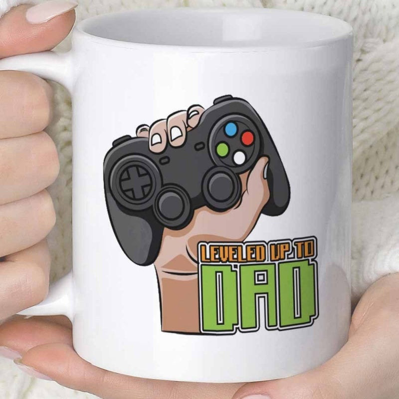 Tailorly White Ceramic 11 oz Mug - Leveled Up To Dad Hand Holding A Detailed Black Gaming Controller With Vibrant Buttons Controller