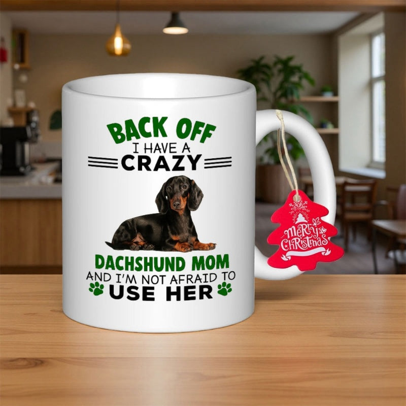 Tailorly White Ceramic 11 oz Mug - Back Off I Have A Crazy Dachshund Mom And I Am Not Afraid To Use Her Loyal Black And Tan Dog Resting Calmly On Surface Dachshund