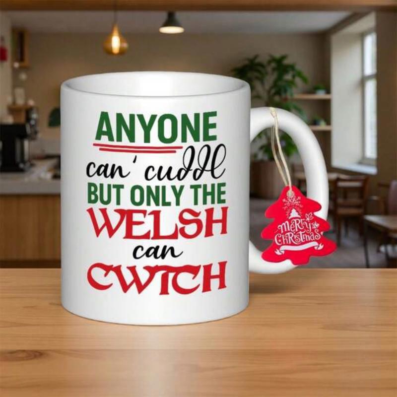 Tailorly White Ceramic 11 oz Mug - Anyone Can Cuddle But Only The Welsh Can Cwtch White Ceramic Vessel Featuring Colorful Typography With Festive Red Christmas Tag