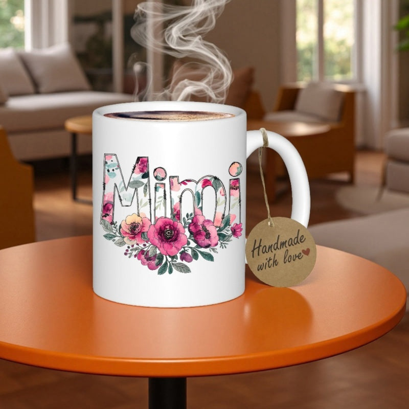 Tailorly White Ceramic 11 oz Mug - Mimi Blooming Pink Floral Letters With Green Leaves Resting On Table Mug
