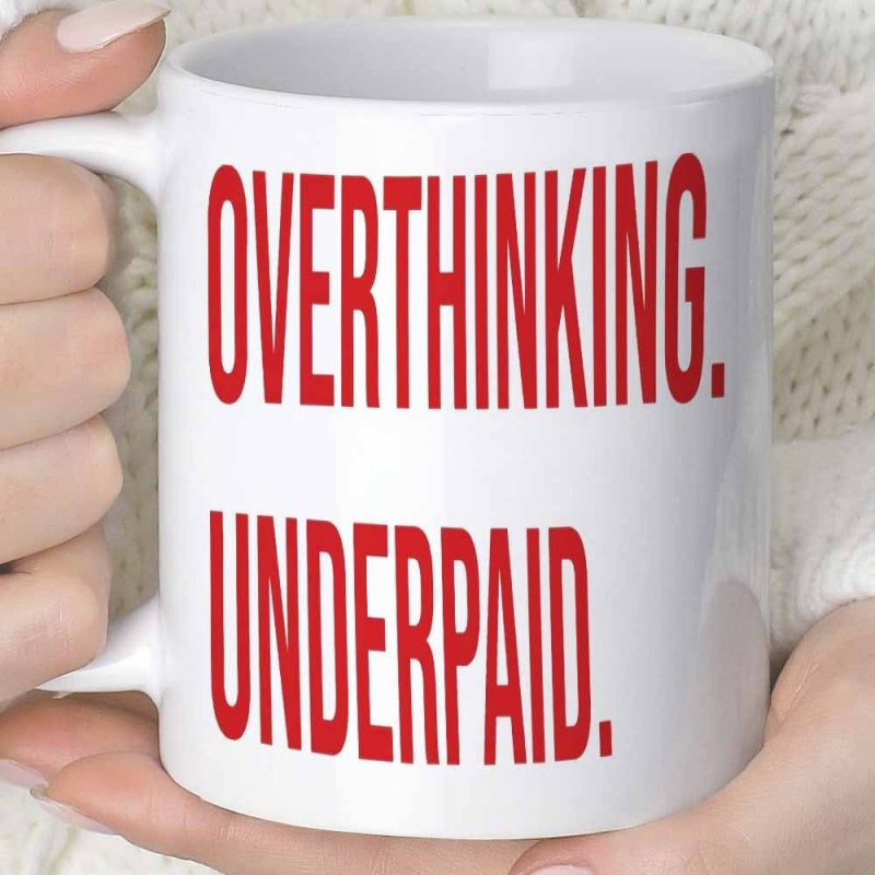Tailorly White Ceramic 11 oz Mug - Overthinking Underpaid Bold Condensed Red Typographic Design Displayed On A