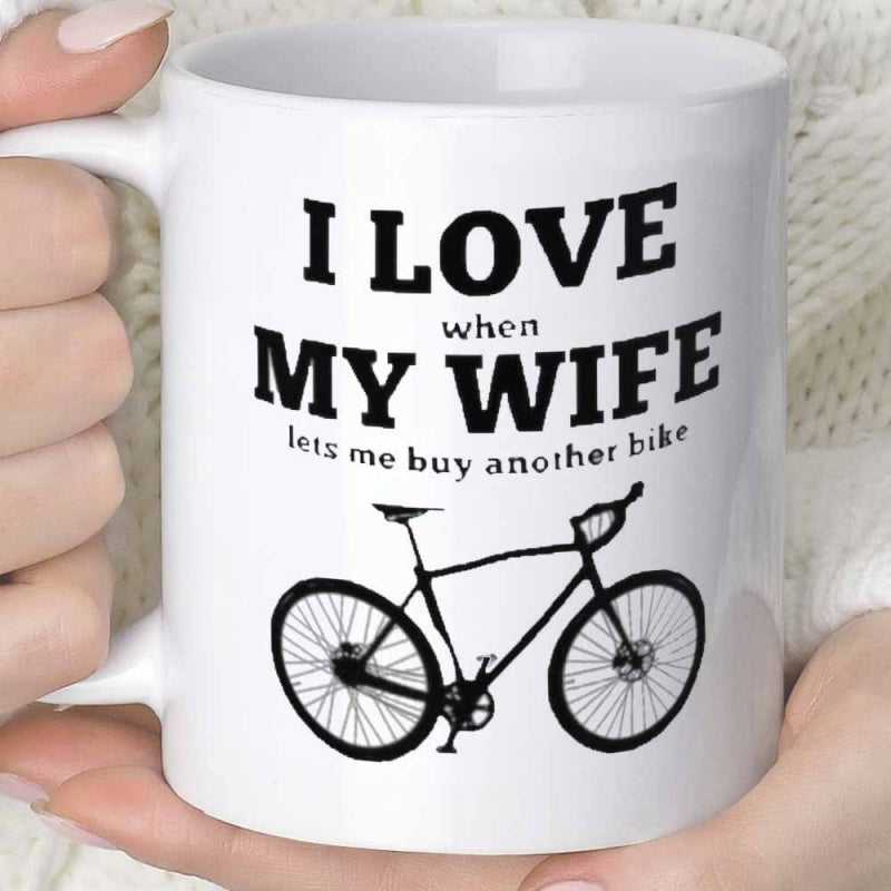 Tailorly White Ceramic 11 oz Mug - I Love When My Wife Lets Me Buy Another Bike Simple Black Road Silhouette Centered Under Bold Humorous Typography Bicycle