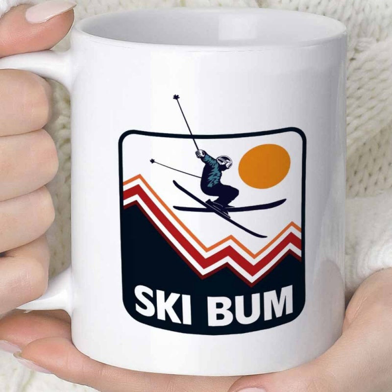 Tailorly White Ceramic 11 oz Mug - Ski Bum Silhouette Jumping High Over Winter Peaks Under An Orange Sun Skier