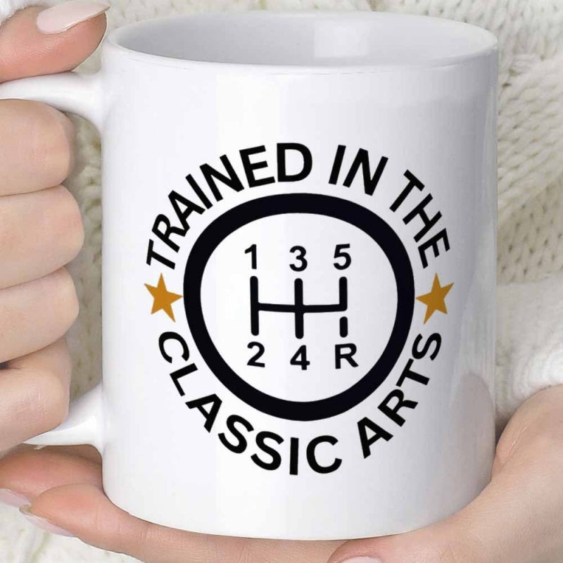 Tailorly White Ceramic 11 oz Mug - Trained In The Classic Arts Circular Emblem Featuring Manual Transmission Pattern With Two Golden Stars Shifter
