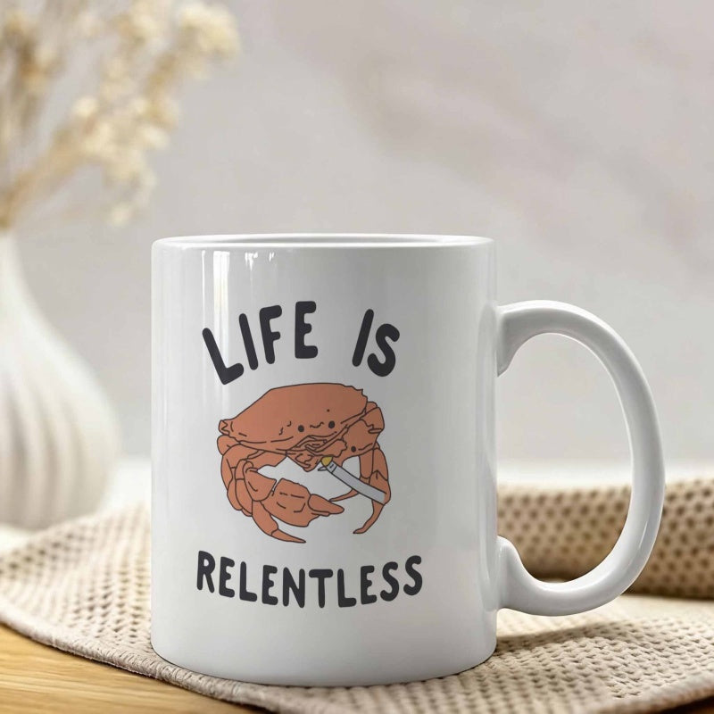 Tailorly White Ceramic 11 oz Mug - Life Is Relentless Humorous Cartoon Brown Shell Crab Gripping A Sharp Knife Crab