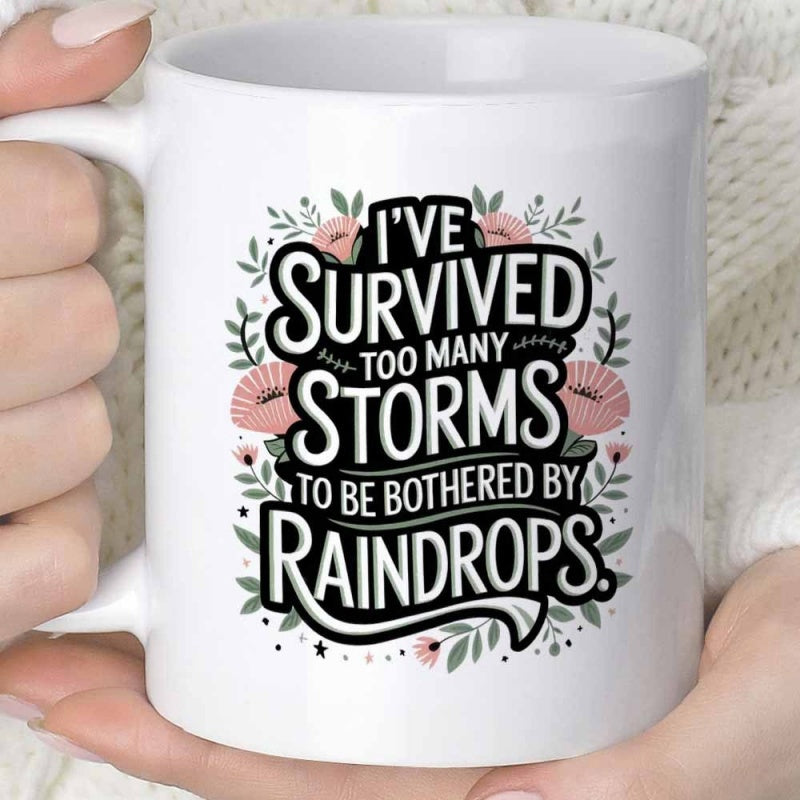 Tailorly White Ceramic 11 oz Mug - I've Survived Too Many Storms To Be Bothered By Raindrops Delicate Pink Flowers And Green Leaves Forming A Decorative Circular