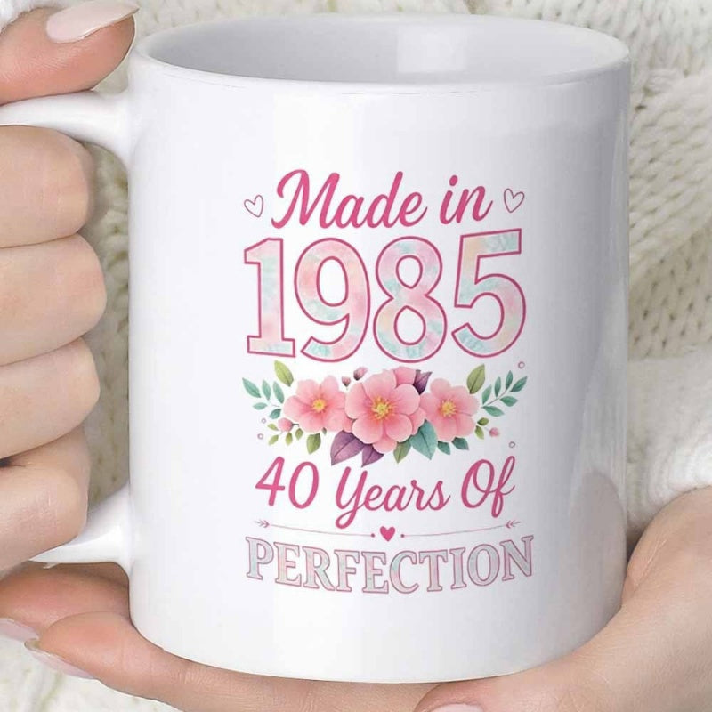 Tailorly White Ceramic 11 oz Mug - Made In 1985 40 Years Of Perfection Elegant Floral Arrangement Featuring Pink Blossoms Surrounded By Decorative Green Leaves Mug