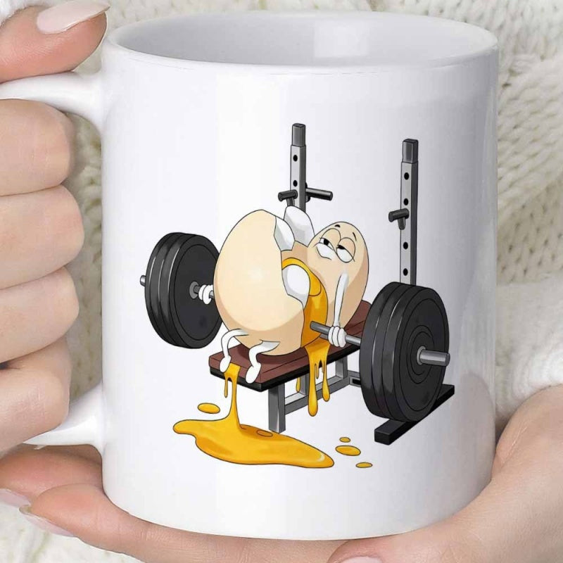 Tailorly White Ceramic 11 oz Mug - Funny Cartoon Cracked Egg Lifting Heavy Barbell On Gym Weight Bench Egg
