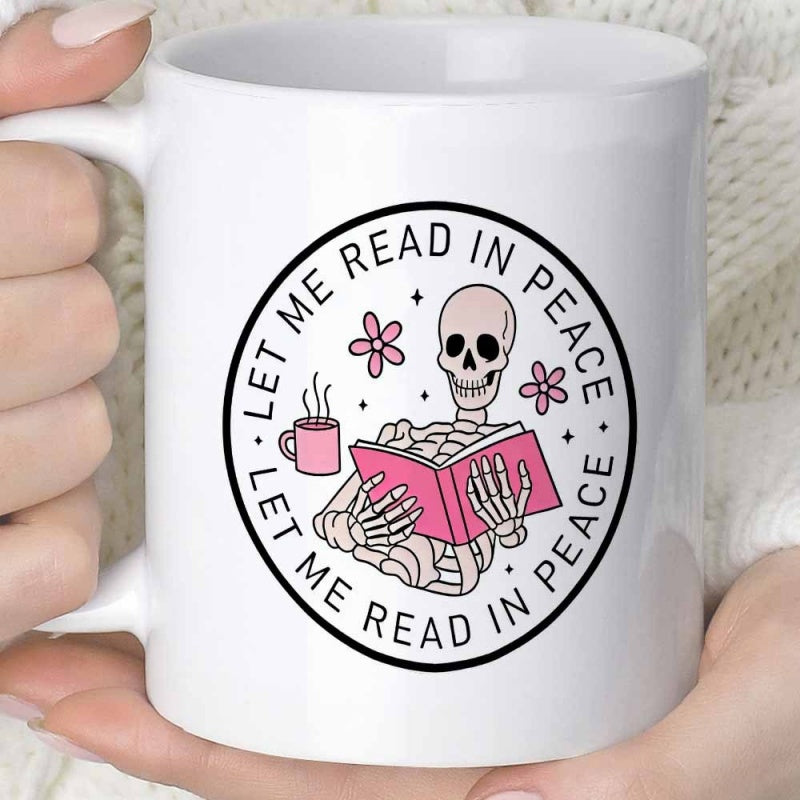 Tailorly White Ceramic 11 oz Mug - Let Me Read In Peace Chilling Skeleton Holding A Pink Book With Steaming Coffee Cup And Flowers Skeleton