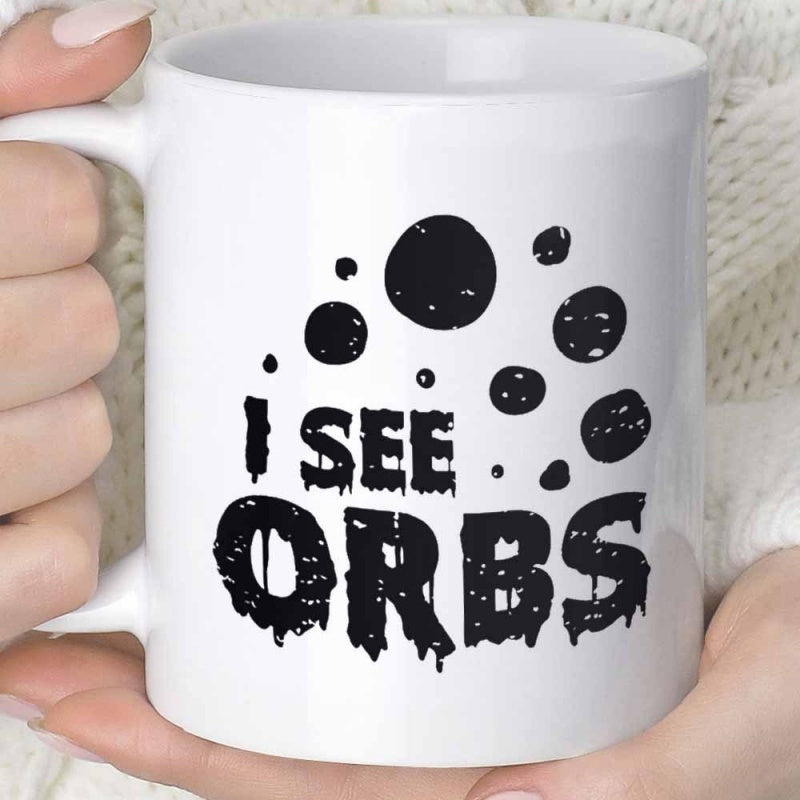 Tailorly White Ceramic 11 oz Mug - I See Orbs Distressed Black Circles Floating Above Bold Text On A White Surface Mug