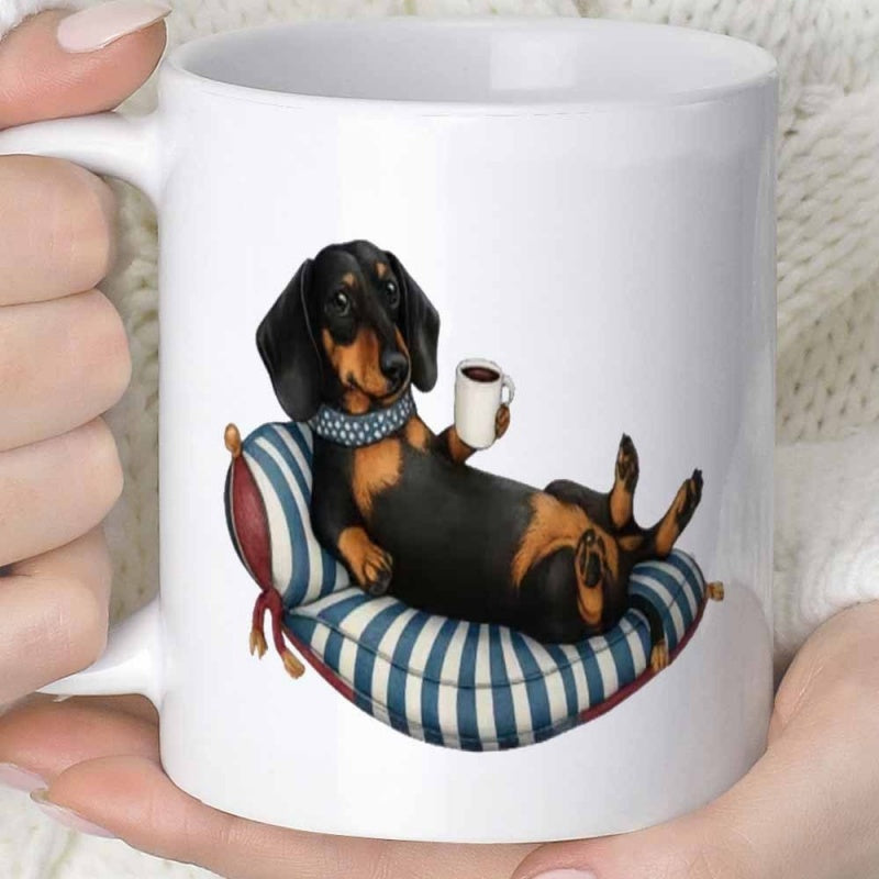 Tailorly White Ceramic 11 oz Mug - Relaxed Black And Tan Dog Reclining On Striped Cushion Holding Coffee Dachshund