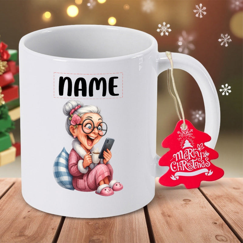 Tailorly White Ceramic 11 oz Mug - Name Merry Christmas Cozy Cartoon Sitting On Cushion Holding Mobile Phone Wearing Glasses Grandmother