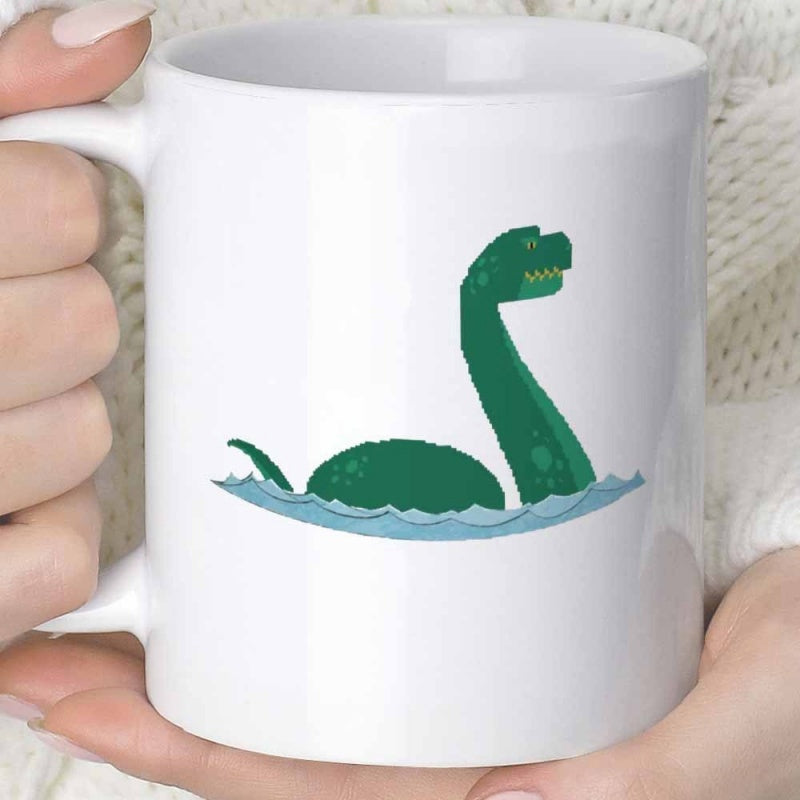 Tailorly White Ceramic 11 oz Mug - Cartoon Green Sea Monster Swimming Gracefully Through Calm Blue Water Ripples Loch Ness Monster