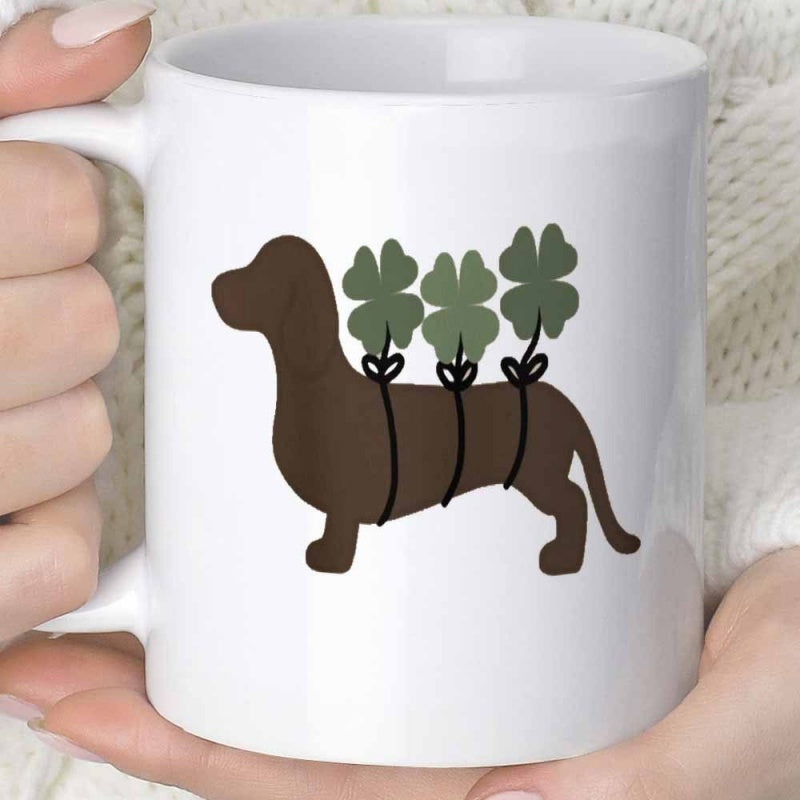 Tailorly White Ceramic 11 oz Mug - Small Brown Dog Silhouette Carrying Three Lucky Green Clovers Tied With Ribbons Dachshund