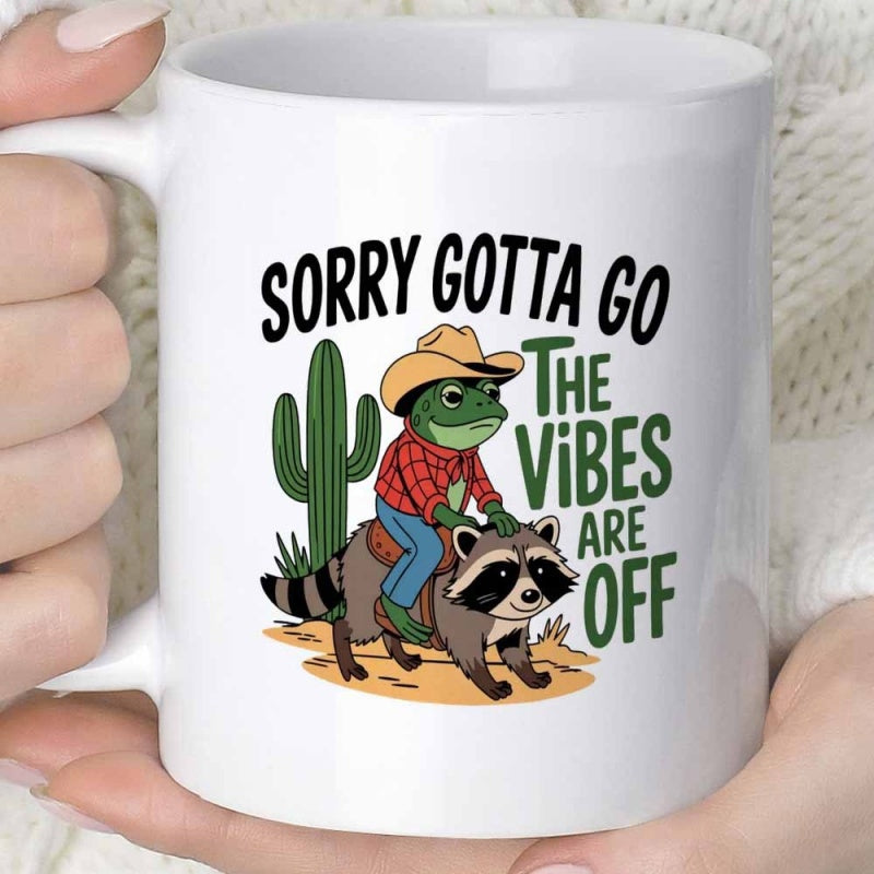 Tailorly White Ceramic 11 oz Mug - Sorry Gotta Go The Vibes Are Off Quirky Cartoon Cowboy Frog Riding On A Fluffy Forest Raccoon