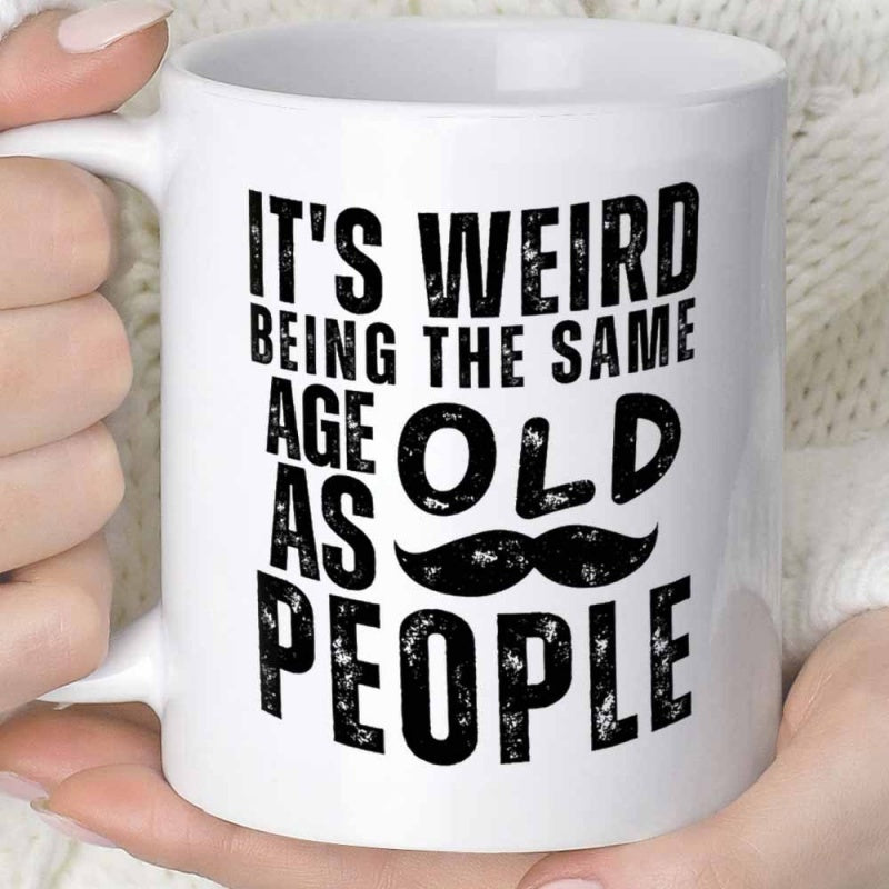 Tailorly White Ceramic 11 oz Mug - Its Weird Being The Same Age As Old People Bold Distressed Typography Centered Above A Simple Black Groomed Mustache Mug