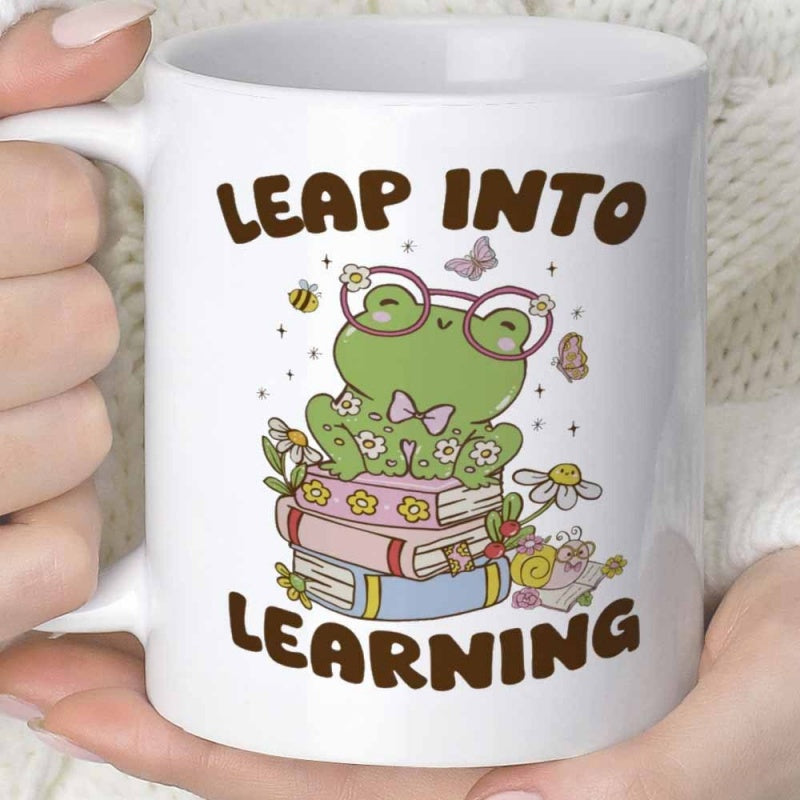 Tailorly White Ceramic 11 oz Mug - Leap Into Learning Adorable Green Frog Wearing Glasses Sitting On Stacked Books Among Flowers Frog
