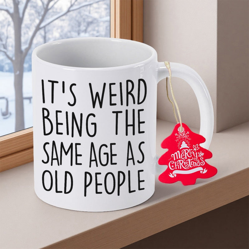 Tailorly White Ceramic 11 oz Mug - Its Weird Being The Same Age As Old People Minimalist Ceramic Vessel Sitting On A Window Ledge Near Winter Scenery Mug