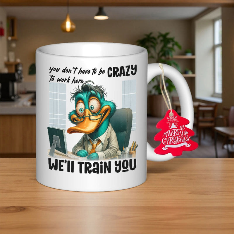 Tailorly White Ceramic 11 oz Mug - You Don't Have To Be Crazy To Work Here We'll Train You Stressed Blue Cartoon Duck Sitting At Computer Desk Wearing Professional