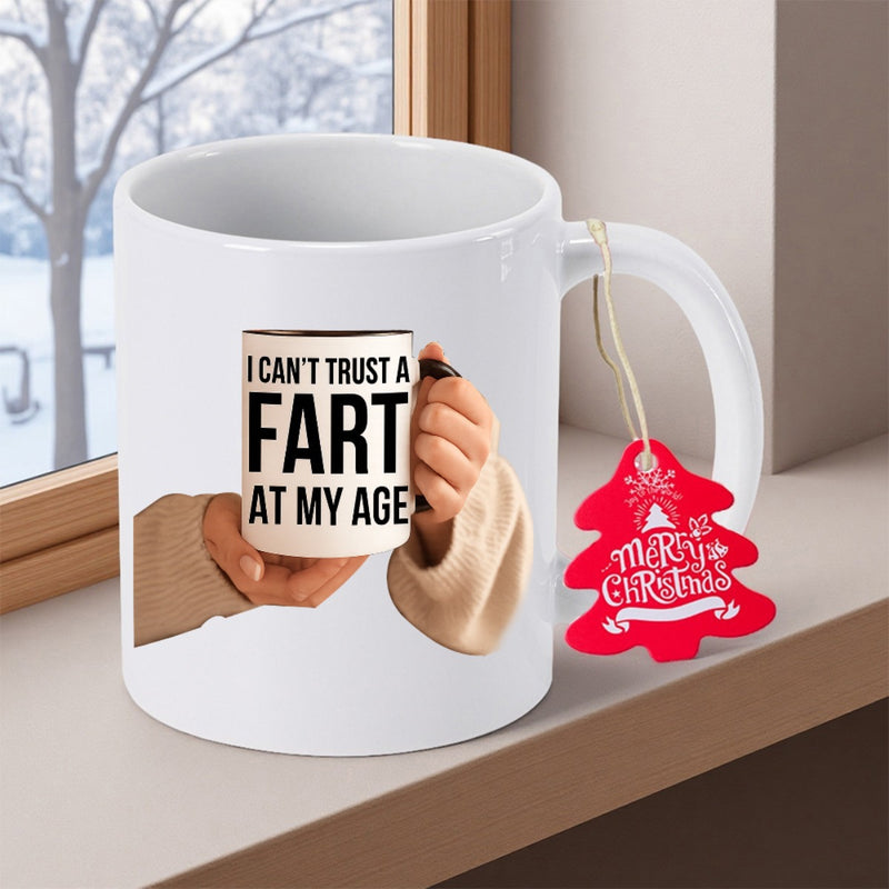 Tailorly White Ceramic 11 oz Mug - I Cant Trust A Fart At My Age Merry Christmas Hands Holding Small Cup With Red Holiday Tree Tag Attached Mug