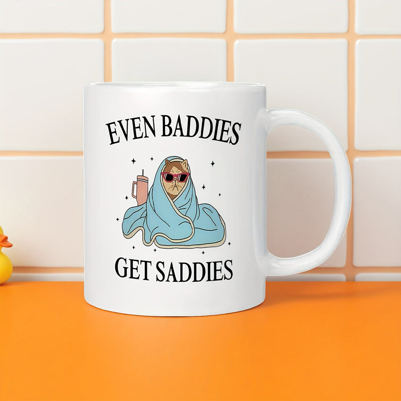 Tailorly White Ceramic 11 oz Mug - Even Baddies Get Saddies Cozy Figure Wrapped In Blue Blanket Wearing Sunglasses Holding Tumbler Person